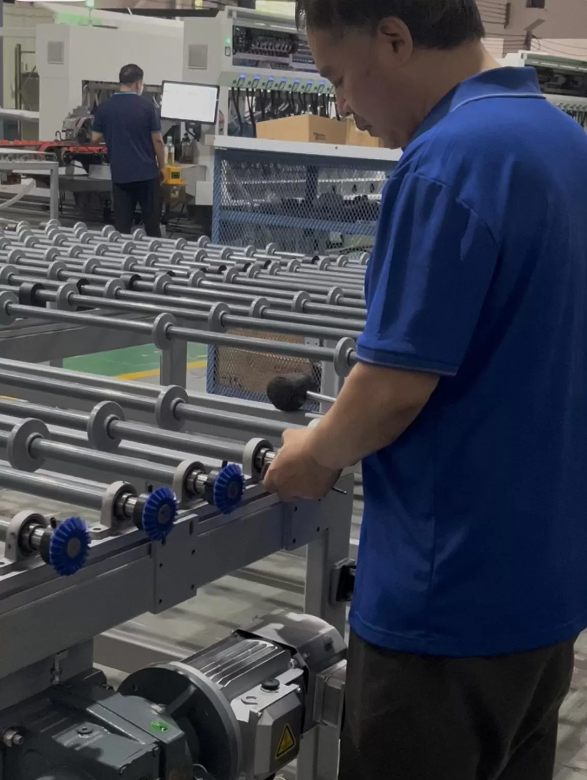 Skilled technician assembling and commissioning glass transfer table Skilled technician assembling and commissioning glass transfer table