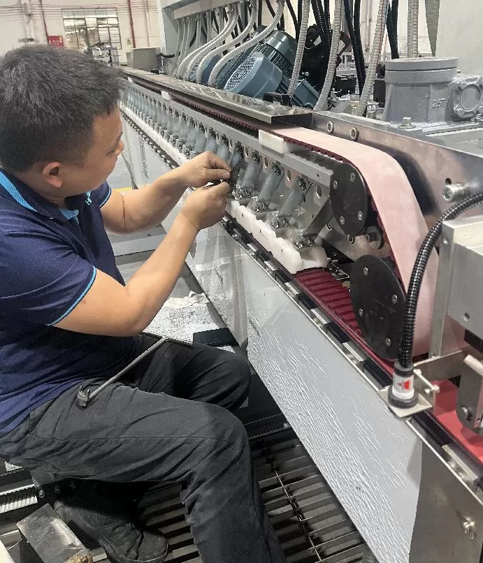 The worker is adjusting the spring press block of glass machine The worker is adjusting the spring press block of glass machine
